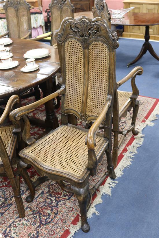 A set of twelve Dutch style carved oak caned dining chairs, all with arms